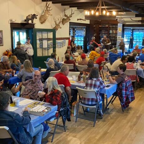 Crowd gathered in a charming, timeless venue with warm atmosphere