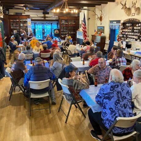 People socializing in a cozy gathering place with classic, timeless charm